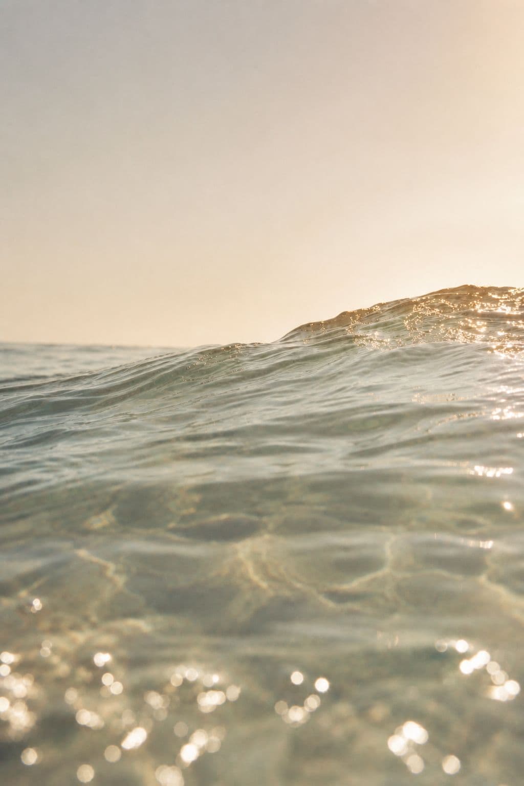 Sunlit clear water surface at golden hour