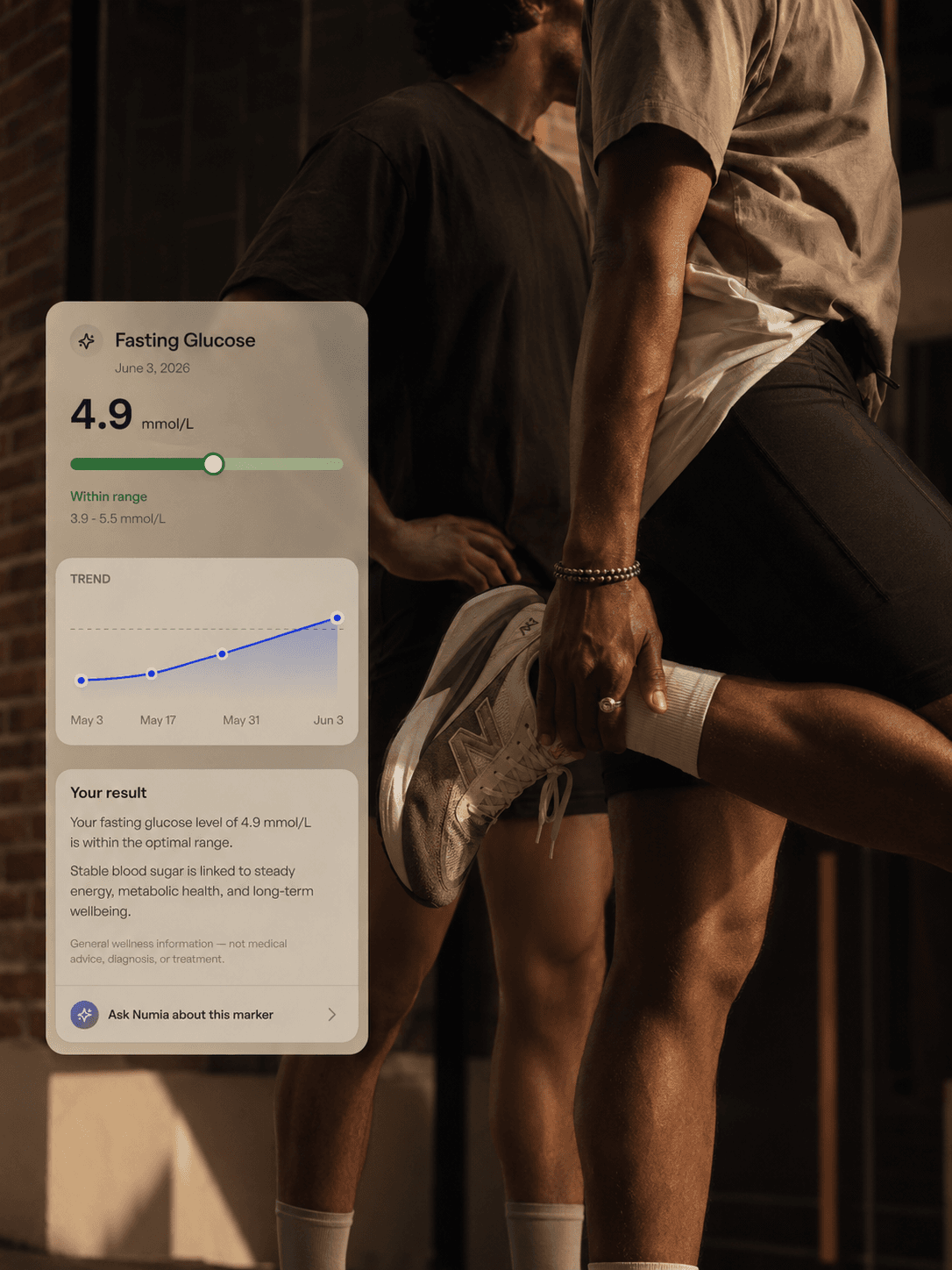 A person stepping on a scale at home, with metabolic markers shown in the Numia app