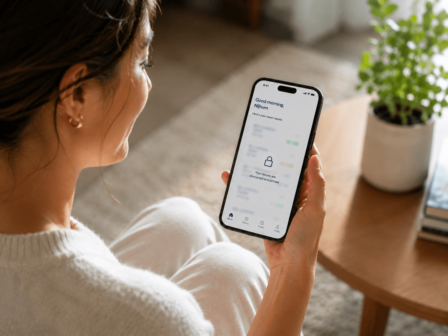 A person viewing their encrypted, private results in the Numia app